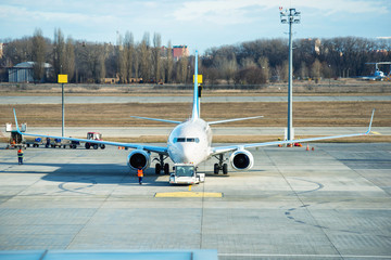 Servicing of buisines transportation in international airport. Loading cargo into plane before...