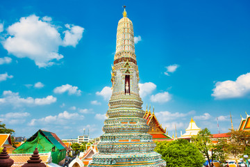 View of side tower of Wat Arun on blue sky background. Religious and architectural landmark in Bangkok, Thailand