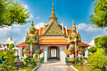 View to beautiful gates of Ordination Hall with statues of Giants, demon guardians. Wat Arun temple, Bangkok, Thailand