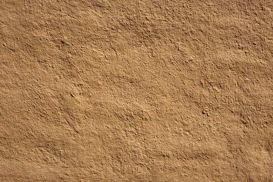 Soil wall texture of clay house structure, wall home made from mud with vintage tone picture. Soft picture