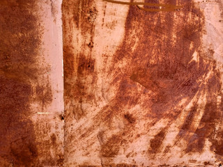 Texture of a rusty sheet of metal. Corrosion of red metal, the paint is randomly applied in different directions. An example of improper metal care, a striking garage surface