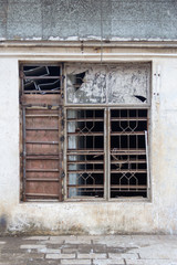 old windows with bars in the factory wall