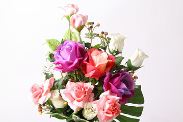 Colorful flower arrangement centerpiece in white ceramic vase