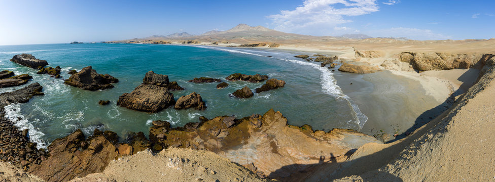 Panoramic view of a rocky beach with  algaes and blue seawater at Huarmey&acute;s seaside in Ancash region, Peru