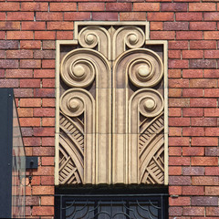 Art Deco architectural feature on the facade of an old pub. Decorative tiles make up the design...