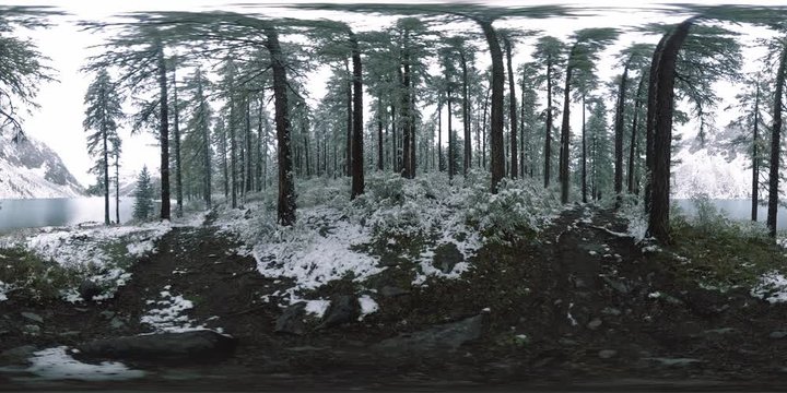 Mountain lake 360 vr at the winter time. Wild nature and mount valley. Green forest of pine trees and fast clouds on sky.