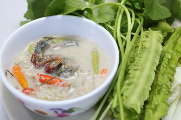 Soya bean dipping sauce with crab served with fresh vegetables isolated on white background, close up view