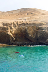Two fishing boats close to the shore at the seaside of Huarmey in Ancash Region, Peru