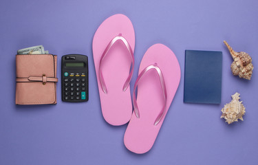 Calculation of the cost of rest. Summer background. Traveler, beach accessories, calculator on purple background. Top view.