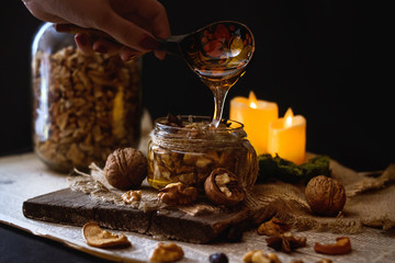  honey in a jar with nuts on a wooden background