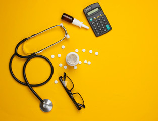 Doctoral supplies and tools, calculator on a yellow background. An economic calculation of the...