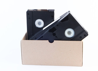 Cardboard box with video cassettes on a white background