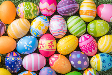 Happy Easter with colorful eggs at paintbrush for do it yourself on the grass with close up from...