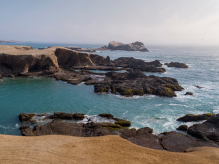 Rocky beach with blue seawater at Huarmey´s seaside in Ancash region, Peru