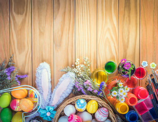Happy Easter day colorful eggs and flower a set of food coloring, acrylic paintbrush for do it yourself on brown wooden floor with copy space