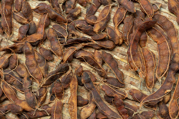Dried tamarind, peeled and placed on rattan trays.