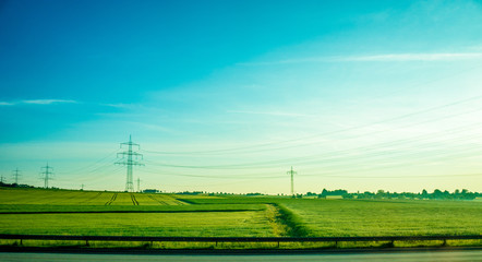 Fototapeta na wymiar Germany, Frankfurt, Sunrise, a large green field with trees in the background