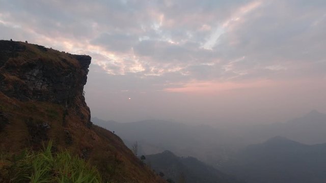 Time lapse of beautiful sunrise at Phu Chi Fah National Park, A tourist destination on a hilltop during the foggy and beautiful light in the morning and sunset in Chiang Rai Thailand 