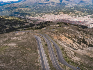 Fototapeta na wymiar Aerial view of the roadway to Huaraz city with green mountains in the background in the Peruvian Andes
