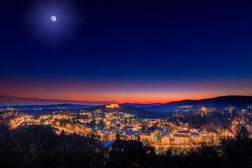 sunset in the mountains, this beautiful view can be found in Königstein, Germany.  a great sunset in winter over a great hilly landscape with a village