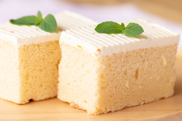 Sliced of cheesecake with mint leaves decorated on top.