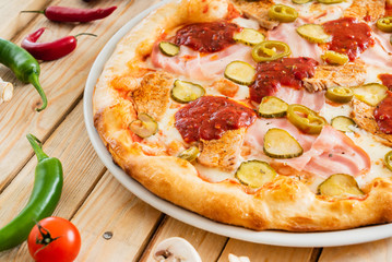 tasty pizza on the wooden background