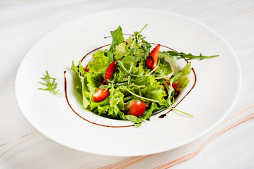 healthy salad with strawberriesa and arugula