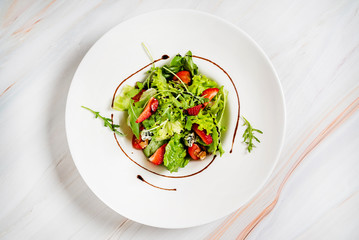 healthy salad with strawberriesa and arugula