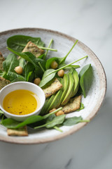 vegetarian food salad, avocado, chickpeas, spinach, olive oil with snack