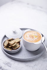 Pumpkin soup served with snack