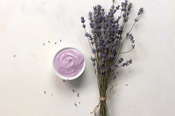 fresh yogurt with lavender  with fresh lavender on white marble board, healthy diet