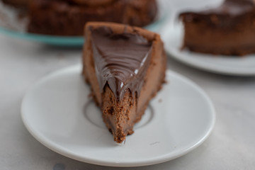 home made chocolate cheesecake on a wooden table - obrazy, fototapety, plakaty