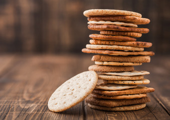 Stack of various organic crispy wheat, rye and corn flatbread crackers with sesame and salt on...