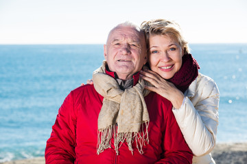 Mature couple walking by sea