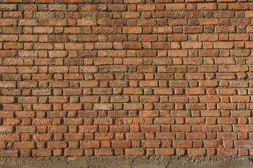 Detail of a house´s wall made of red bricks at a sunny day