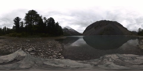 Mountain lake 360 vr at the summer or autumn time. Wild nature and rural mount valley. Green forest of pine trees and fast clouds on sky.