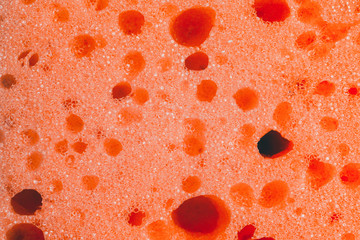 Pink sponge for washing closeup, close-up porous texture.