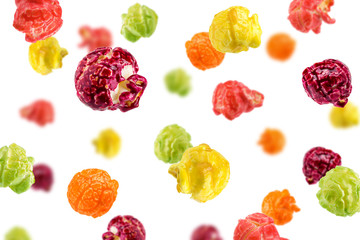 Falling Colored fruity popcorn isolated on white background, selective focus