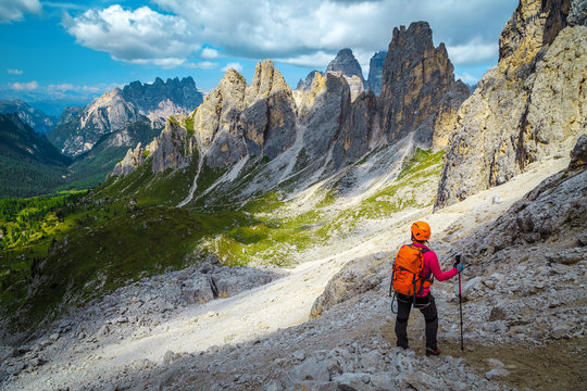Woman hiker with backpack on the hiking trail, Dolomites, Italy
