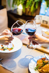 Man and woman drinking red wine in the restaurant