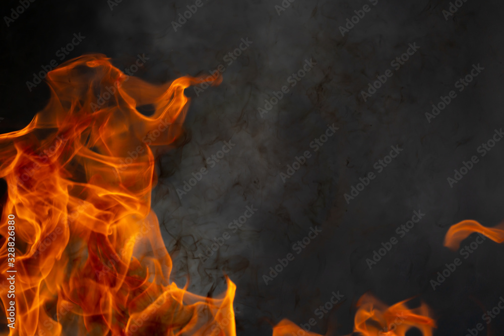 Wall mural Abstract fire flame glowing burning on black dark background, photo for creative graphic design wallpaper, beautiful flame light motion of bonfire