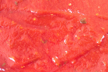 background with ketchup (filling in the picture). the texture of ketchup with some greenery.