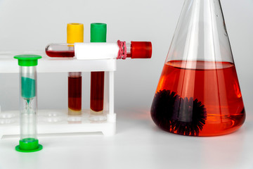 study of coronavirus. chemical flask with molecules of the virus. est tubes rack with blood sample...