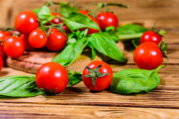 Heap of small cherry tomatoes on wooden table
