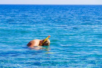 Man with snorkeling tube in sea