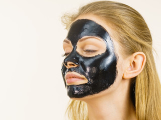 Girl black carbo peel off mask on face