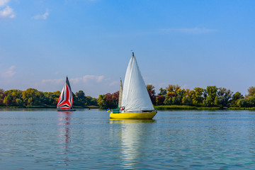 Obraz premium Yachts at the river Dnieper on autumn in Kremenchug, Ukraine. Sailing regatta