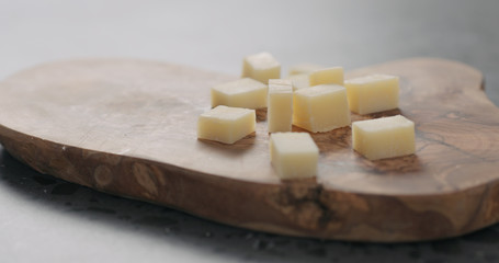 parmesan cheese pieces on wood board