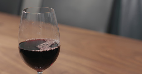 wineglass with red wine on walnut table with copy space