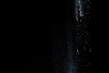 Started splash of white flour powder on black background